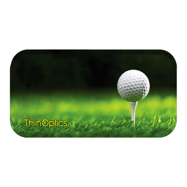 A white golf ball sits on a tee in the middle of a putting green, showcasing the precision and clarity offered by ThinOptics reading glasses.