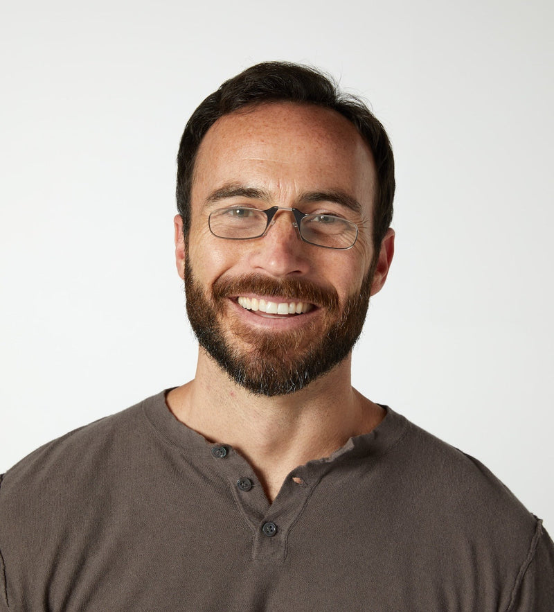 Man wearing ThinOptics pince-nez Readers and smiling.
