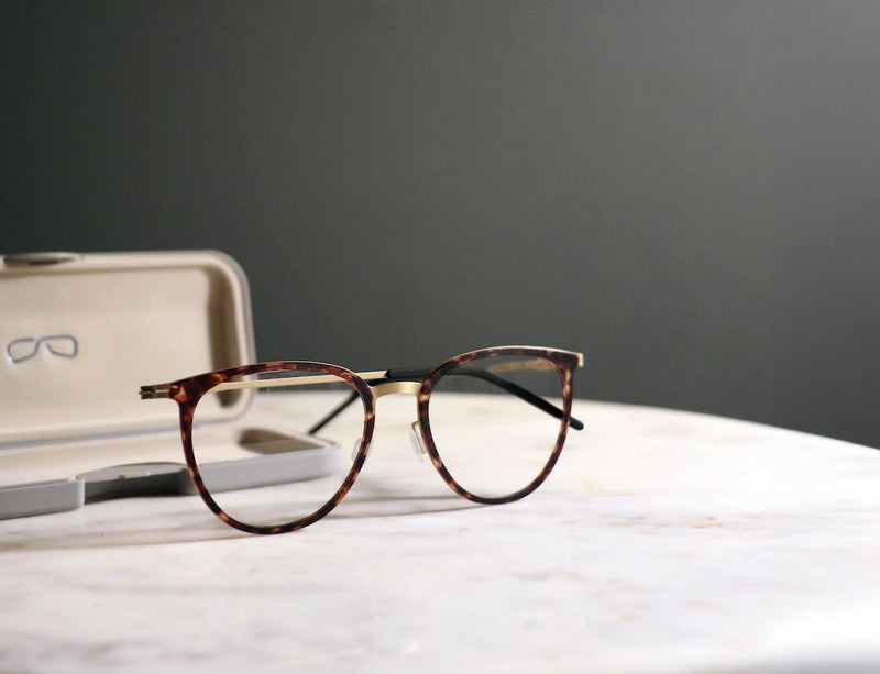 Halo Perch Tortoise Prescription Glasses with its case on a table.