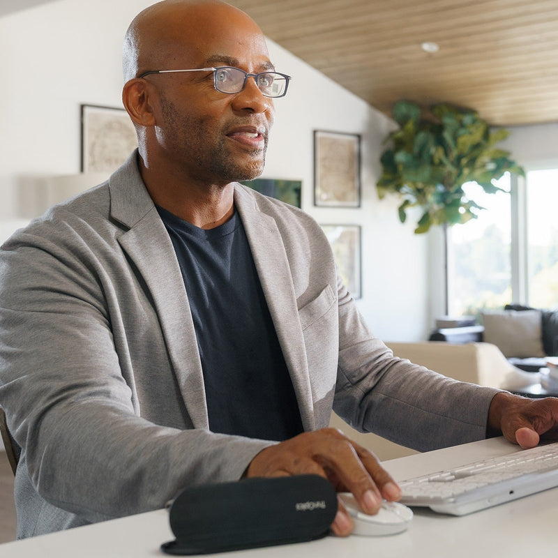 Man wearing black rectangular Reading Glasses and working on his computer.