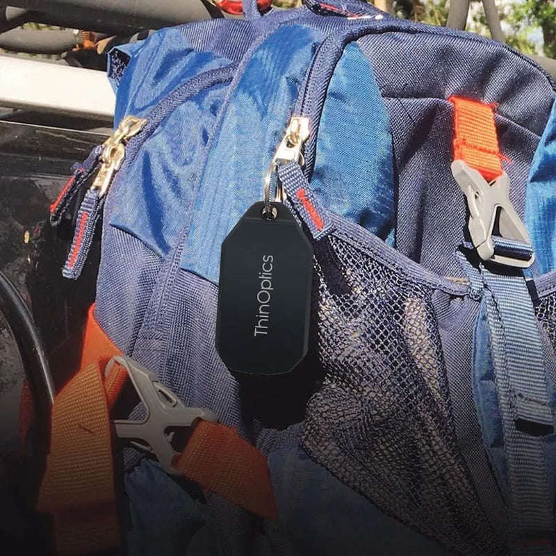 ThinOptics Keychain Case attached to a backpack.