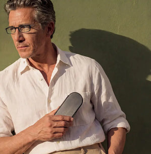 Man wearing modern rectangular reading glasses with a slim ThinOptics case for everyday use.