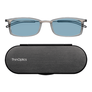 ThinOptics Clear Reading Glasses with Blue Light Blockers and a sleek black case: minimalist design with thin lenses. The compact, brushed metal case offers a modern, portable solution for individuals needing reading glasses.