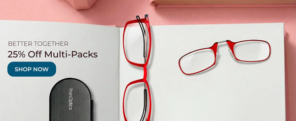 Red reading glasses and ThinOptics case on flat surface