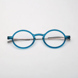 ThinOptics Manhattan Rx Glossy dark blue round prescription glasses folded flat, top-down view