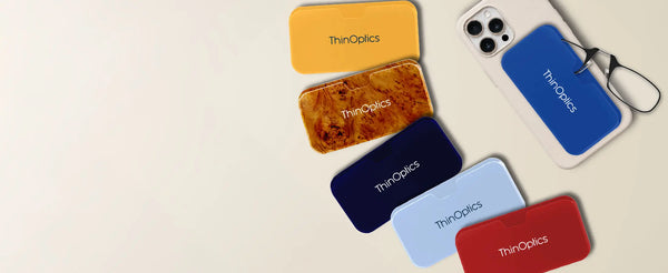 ThinOptics Universal Pod Cases in new colors: yellow, burlwood, navy, light blue, red, and royal blue attached to an iPhone