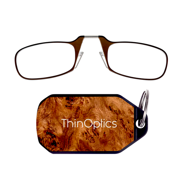 ThinOptics brown armless reading glasses above a burlwood keychain case
