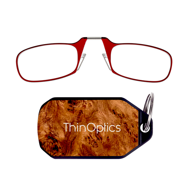ThinOptics red armless reading glasses above a burlwood keychain case