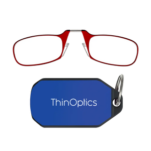 ThinOptics red armless reading glasses above a royal blue keychain case on a white background