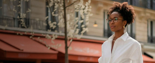 Woman wearing ThinOptics prescription glasses outdoors in a city setting
