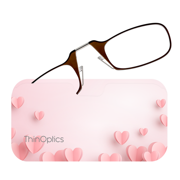 Brown Frames peeking out of a Pink Hearts Universal Pod Case being held up to a screen