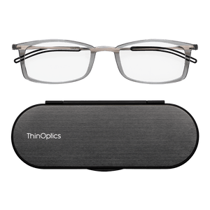 ThinOptics reading glasses and a sleek black case: minimalist design with thin lenses. The compact, brushed metal case offers a modern, portable solution for individuals needing reading glasses.