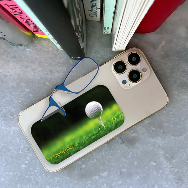 Blue ThinOptics Readers peeking out of a Tee Off Universal Pod attached to a phone being held up by a hand