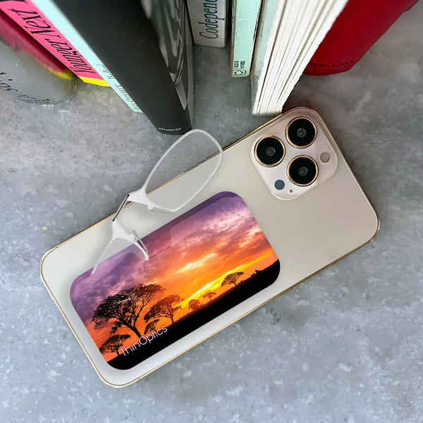 Clear ThinOptics Readers peeking out of a Safari Sunset Universal Pod attached to a phone being held up by a hand